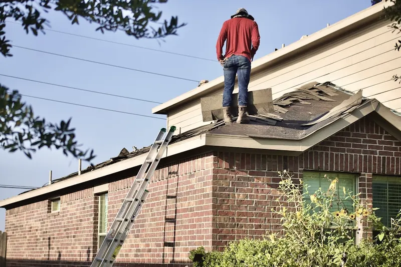 Professional roofer working on a residential roof in Indian Creek Estates
